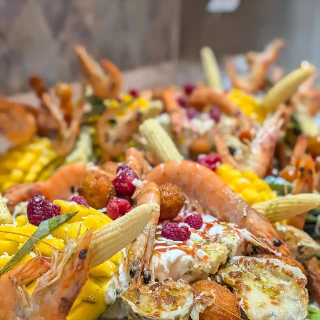 Group of people enjoying food from a food truck.