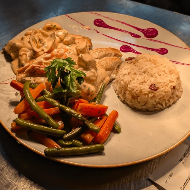 Staff in striped shirts serving inside a food truck.