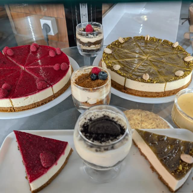Staff in striped shirts serving inside a food truck.